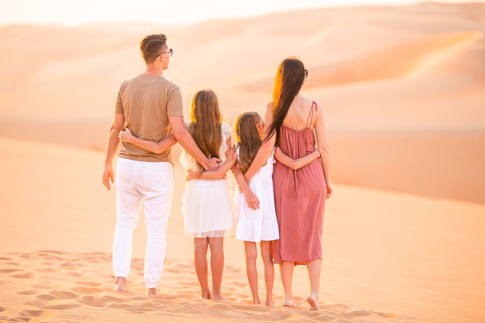 People among Dunes in Desert in United Arab Emirates